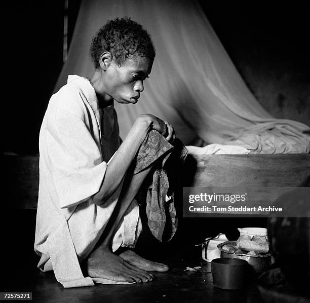 Janet John who is sick and weakened by the AIDS virus pictured at home in Mwanza, Tanzania. It is estimated that 25.4 million people are infected...