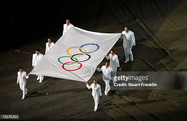 The Olympic flag is carried away during the closing ceremony of the Athens 2004 Summer Olympic Games on August 29, 2004 at the Sports Complex Olympic...