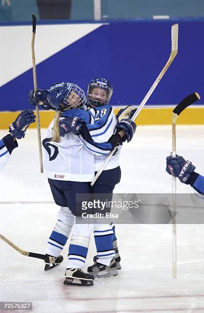 Katja Riipi and Saija Sirvio of Finland celebrate a goal during the Women's Ice Hockey Preliminary Round game between Finland and Germany at the...