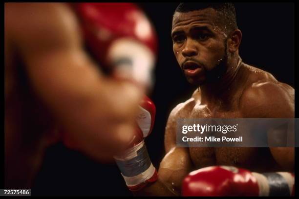 Boxer Roy Jones Jr. Watches the gloves of opponent Vinny Pazienza. Jones retained his International Boxing Federation Super middleweight title by...