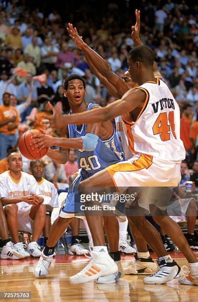 Joseph Forte of the North Carolina Tar Heels gets ready to pass the ball as Isiah Victor of the Tennessee Volunteers during the NCAA South Regional...