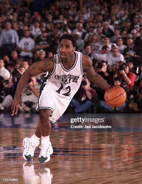 Mateen Cleaves of Michigan State looks for an open pass around the Wisconsin defense during the semifinal round of the NCAA Final Four at the RCA...