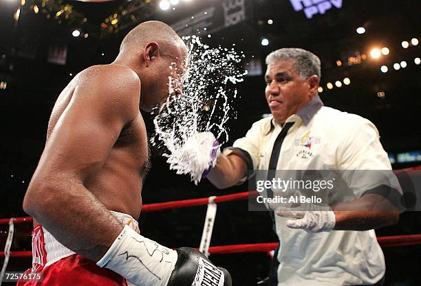 Bebis Mendoza is sprayed with water by his trainer in between rounds during his fight for the WBA light flyweight title against Rosendo Alvarez at...