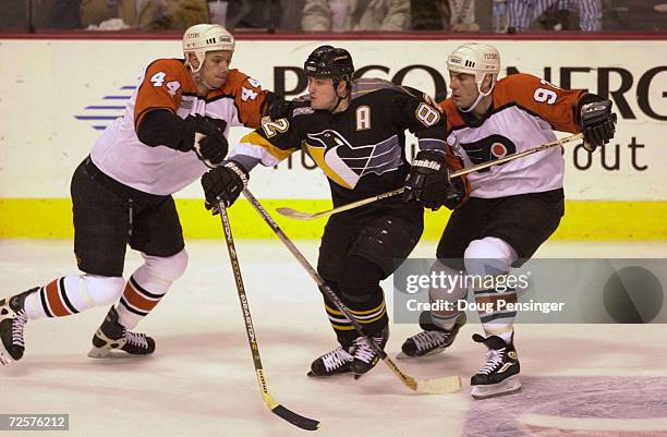 Mark Eaton and Rick Tocchet of the Philadelphia Flyers put the squeeze on Martin Straka of the Pittsburgh Penguins in Game 1 of the Eastern...