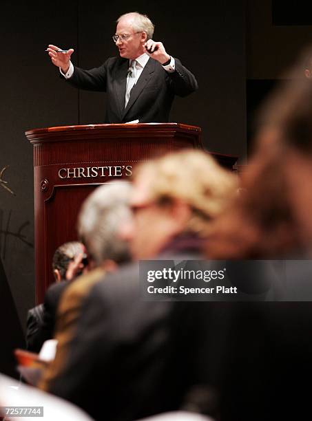 The auctioneer conducts bidding on a work of art inside the auction house Christie's during the Post-War and contemporary Art sale November 15, 2006...