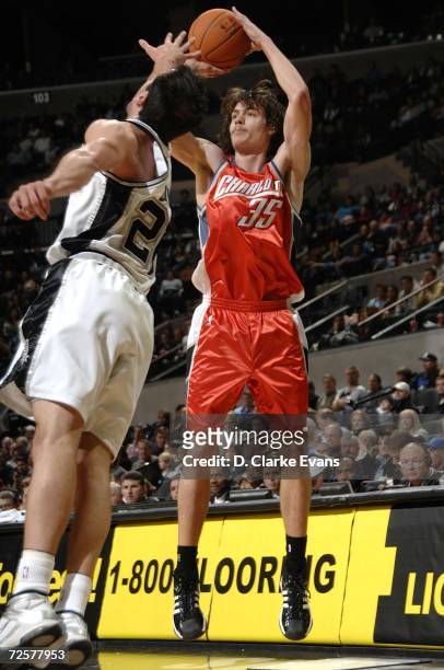 Adam Morrison of the Charlotte Bobcats shoots against Manu Ginobili of the San Antonio Spurs on November 15, 2006 at the AT&T Center in San Antonio,...