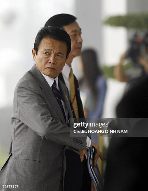 Japanese Foreign Minister Taro Aso arrives to to attend the Asia-Pacific Economic Cooperation 's ministeral meeting opened 16 November 2006 in Hanoi....