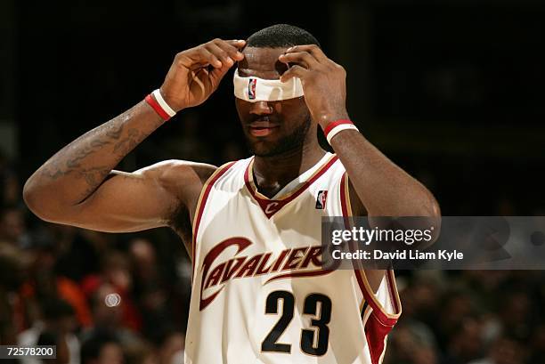 LeBron James of the Cleveland Cavaliers adjusts his headband towards the end of the game against the Portland Trail Blazers on November 15, 2006 at...