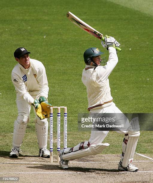 George Bailey of the Tigers smashes a four during day three of the Pura Cup match between the Victorian Bushrangers and the Tasmanian Tigers at the...