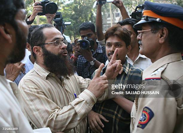 Indian policemen attempt to calm an angry parent outside the Anjuman-i-Islam School in Mumbai, 16 November 2006, after he alledged that bodyguards...