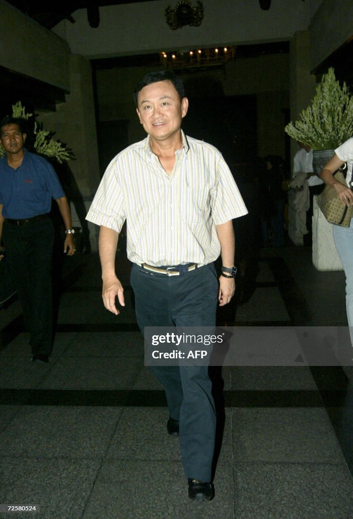 Deposed Deposed Thai Prime Minister Thaksin Shinawtra smiles as he enters the ...
