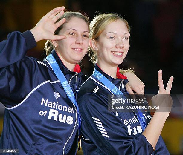 Russian volleyball team players, Ekaterina Gamova and Yulia Merkulova , pose for photographers during an awarding ceremony of the Women's Volleyball...