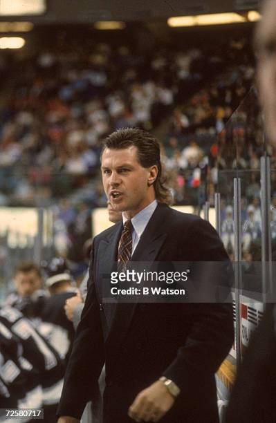 Canadian ice hockey coach Barry Melrose of the Los Angeles Kings behind the bench during a game, October 1992.