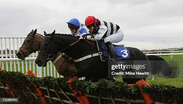 Richard Killoran on Slick enroute to winning the Racing Post 'Hands and Heels' Jumps Series Novices' Handicap Hurdle race from Rebel Raider and...