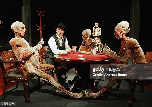 Gunther von Hagens , known as "The Plastinator", poses between a scene of the current James Bond film Casino Royale at the Plastinarium workshop and...
