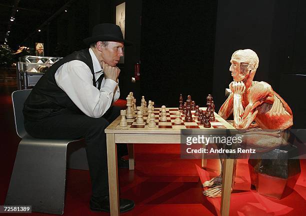 Gunther von Hagens , known as "The Plastinator", poses during a chess match with one of his exhibits at the Plastinarium workshop and showroom during...