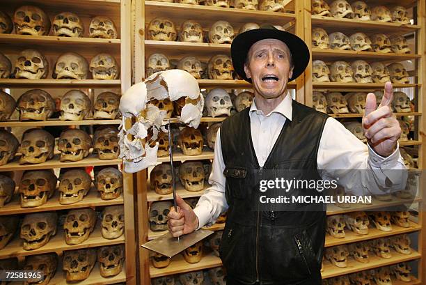 Gunther von Hagens, known as "The Plastinator", poses in front of a shelf full of skulls, during the inauguration of his Plastinarium workshop and...
