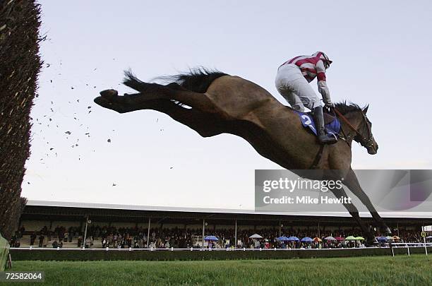 Barry Fenton and Tana River clear the last on their way to victory in the wincantonracecourse.co.uk Handicap Steeple Chase at Wincanton race course...