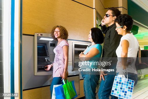 Impatient In Line People Getting Impatient In Long Line At The Atm High-Res Stock Photo ...