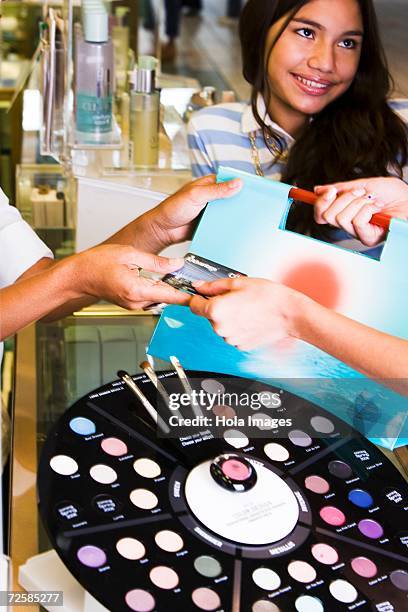 young beautician making a sale - cosmetics counter stock pictures, royalty-free photos & images