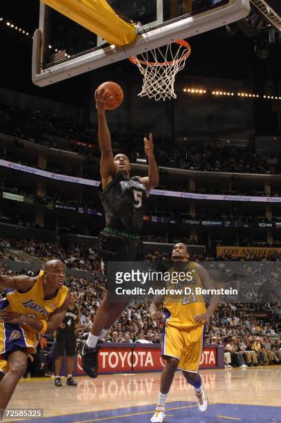 Craig Smith of the Minnesota Timberwolves drives to the basket for a layup past Maurice Evans and Ronny Turiaf of the Los Angeles Lakers during the...