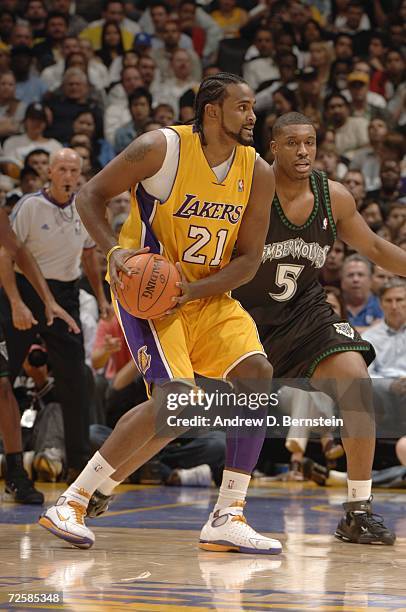 Ronny Turiaf of the Los Angeles Lakers looks to move the ball against Craig Smith of the Minnesota Timberwolves during a game at Staples Center on...