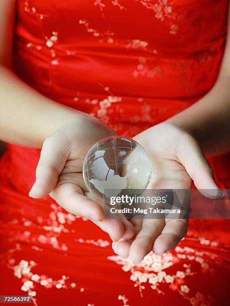 mid section view of a woman holding a globe - world at your fingertips fotografías e imágenes de stock