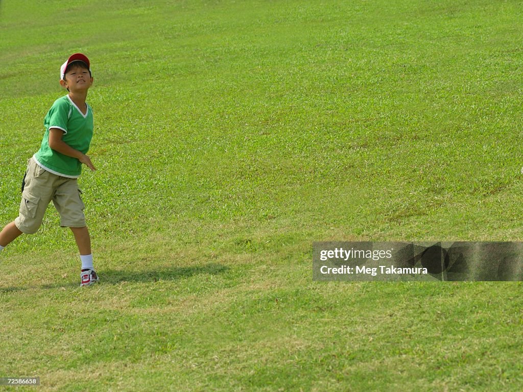 Boy playing catch in a field