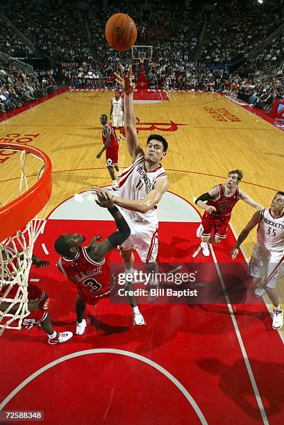 Yao Ming of the Houston Rockets shoots the ball over Ben Wallace of the Chicago Bulls on November 16, 2006 at the Toyota Center in Houston, Texas....