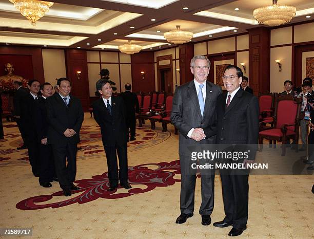 President George W. Bush and Vietnamese Communist Party Secretary General Nong Duc Manh shake hands at a meeting 17 November 2006 at Communist Party...