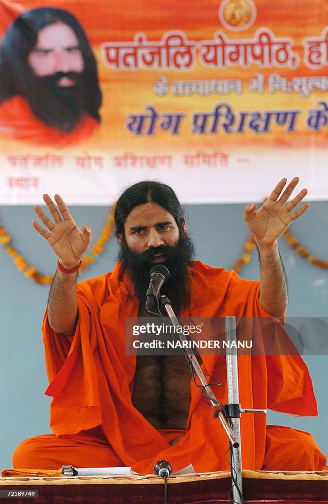 Indian Yoga Guru Swami Ramdev gestures a