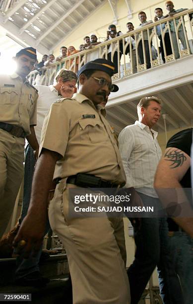 Indian police officials escort bodyguards of unseen US actress Angelina Jolie towards a court appearance in Mumbai, 17 November 2006. Three of...