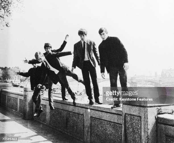The Rolling Stones messing about on a wall at Embankment, London, UK, 4th May 1963.