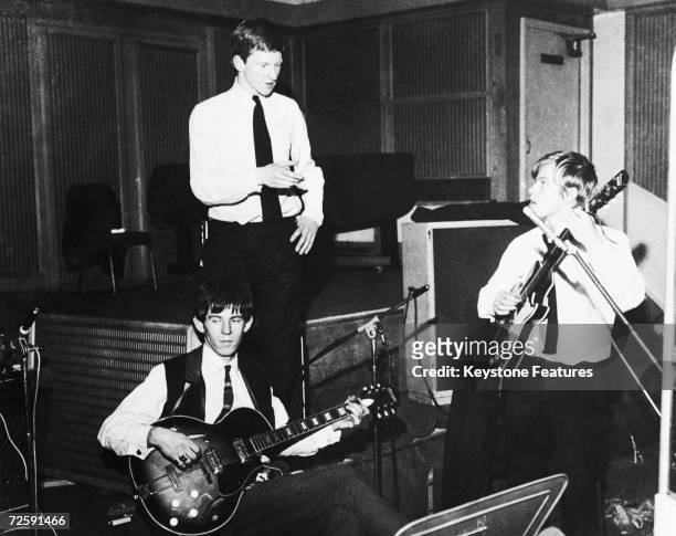 Rolling Stones manager Andrew Loog Oldham giving Brian Jones advice during an early Rolling Stones session, while Keith Richards plays his guitar, at...