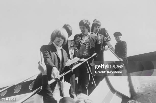 The Rolling Stones arriving at Oslo Airport, 25th June 1965. From left to right, Brian Jones, Keith Richards , Mick Jagger and Bill Wyman.