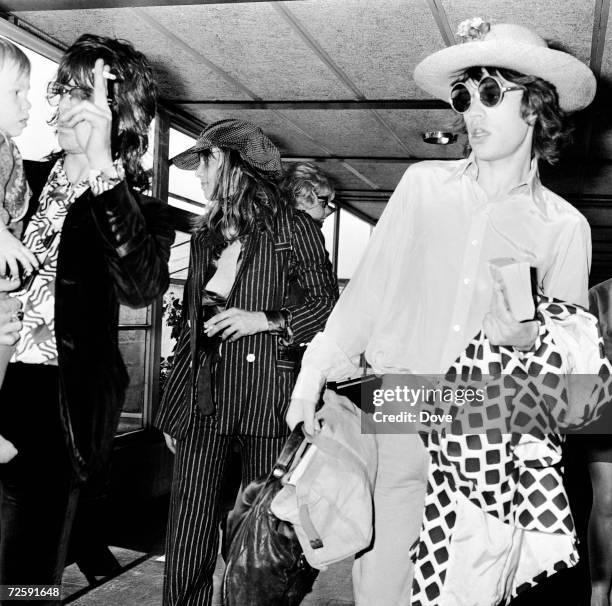 Keith Richards, Anita Pallenberg, their son Marlon and Mick Jagger at London Airport before a flight to Copenhagen, 29th August 1970.