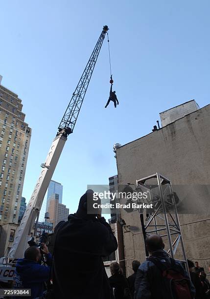 Magician David Blaine hangs from a crane in Times Square on November 17, 2006 in New York City. Blaine announced that his next stunt will be an...