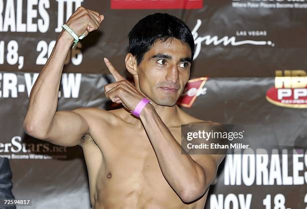Erik Morales of Mexico points to his hand and during the official weigh-in for his bout against Manny Pacquiao of the Philippines at the Thomas &...
