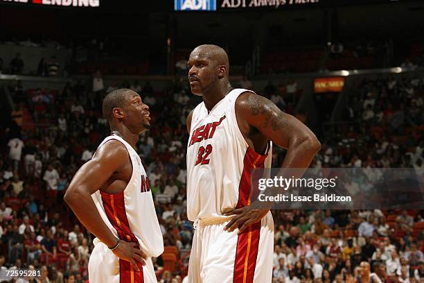 Dwyane Wade and Shaquille O'Neal of the Miami Heat discuss strategy during a game against the New Jersey Nets at American Airlines Arena on November...