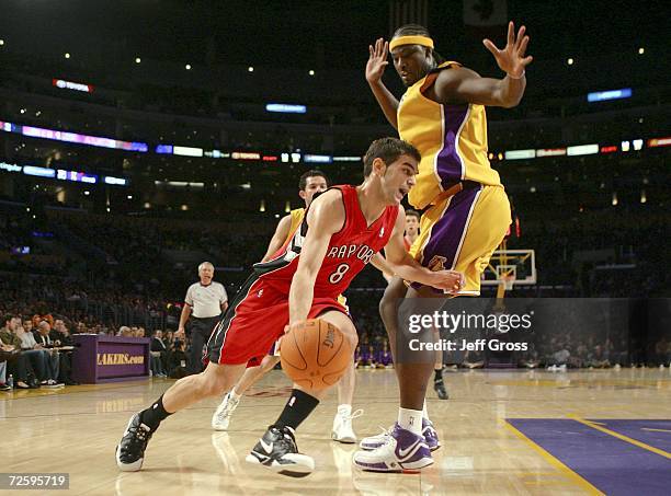 Jose Calderon of the Toronto Raptors drives to the basket past Kwame Brown of the Los Angeles Lakers in the first half November 17, 2006 at Staples...