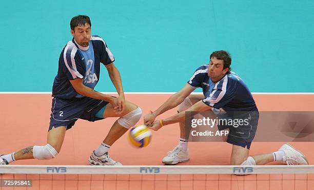Argentina players Jeronimo Bidegain and Gaston Giani fail to return the ball against Poland in the first round Pool A match at the Men's Volleyball...