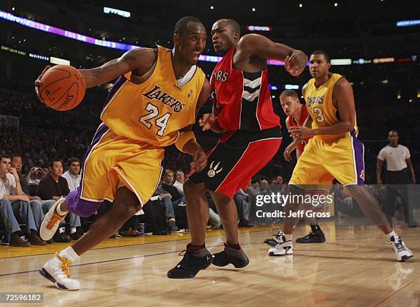 Kobe Bryant of the Los Angeles Lakers drives to the basket past Fred Jones of the Toronto Raptors during the second half of the game on November 17,...