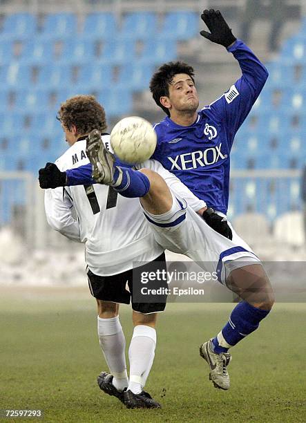 Leandro Fernandez of FC Dynamo Moscow competes for the ball with Pavel Mamayev of FC Torpedo Moscow during the Russian Football League Championship...