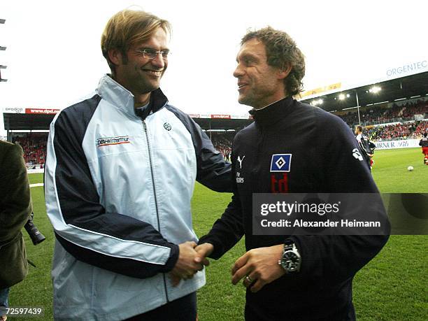 Headcoach Juergen Klopp of Mainz greets headcoach Thomas Doll of Hamburg during the Bundesliga match between FSV Mainz 05 and Hamburger SV at the...