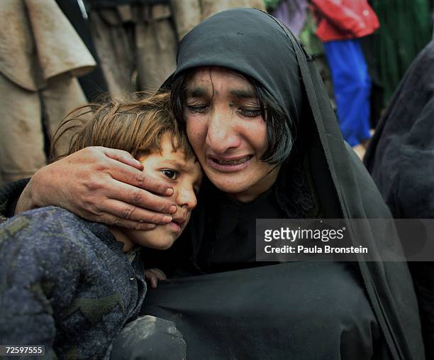 Bibijan mourns the death of her second daughter, Guljan holding her son, Bashir Ahmad on November 14, 2006 in Herat, Afghanistan. She died from...