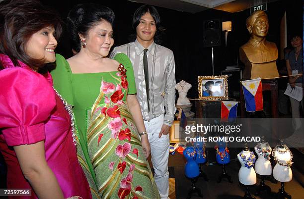 Former first lady Imelda Marcos, , accompanied by daughter Congresswoman Imee Marcos and grandson Borgy Manotoc, a fashion model, pose beside the...