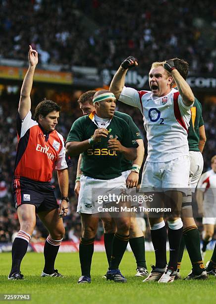 Andy Goode of England celebrates, as Referee Steve Walsh of New Zealand awards the try scored by teammate Phil Vickery during the Investec Challenge...