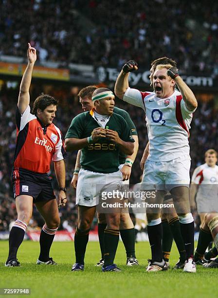 Andy Goode of England celebrates, as Referee Steve Walsh of New Zealand awards the try scored by teammate Phil Vickery during the Investec Challenge...