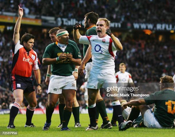 Andy Goode of England celebrates, as Referee Steve Walsh of New Zealand awards the try scored by teammate Phil Vickery during the Investec Challenge...