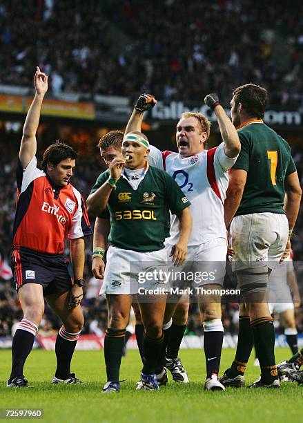 Andy Goode of England celebrates, as Referee Steve Walsh of New Zealand awards the try scored by teammate Phil Vickery during the Investec Challenge...